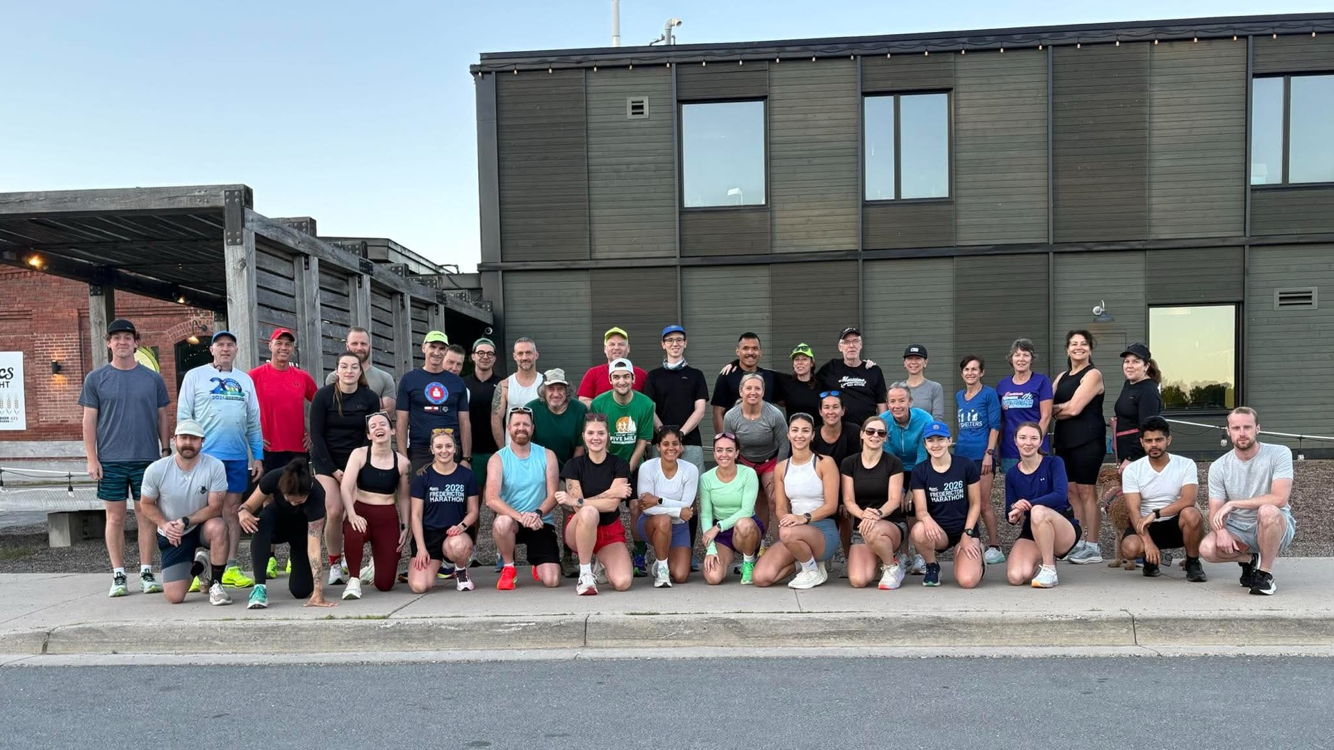 A large group of adult Devon Deer runners posing together outside Picaroons Roundhouse.
